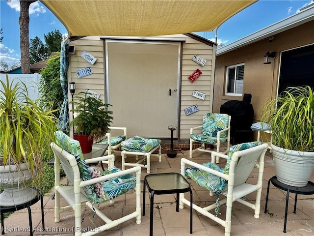 view of patio featuring grilling area, outdoor lounge area, and fence