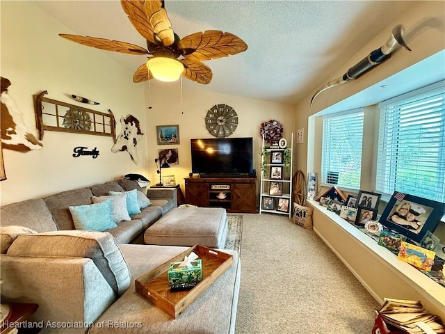 carpeted living room with lofted ceiling, a textured ceiling, a ceiling fan, and baseboards