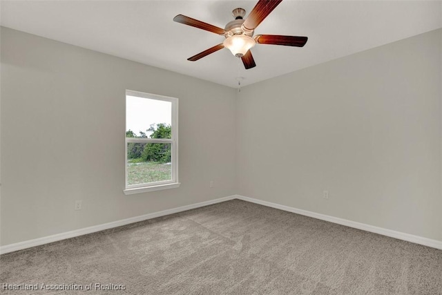 carpeted empty room featuring ceiling fan