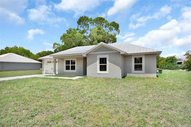 single story home with a garage and a front lawn