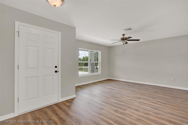 entryway with ceiling fan and dark wood-type flooring