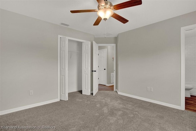 unfurnished bedroom with connected bathroom, ceiling fan, a closet, and carpet floors