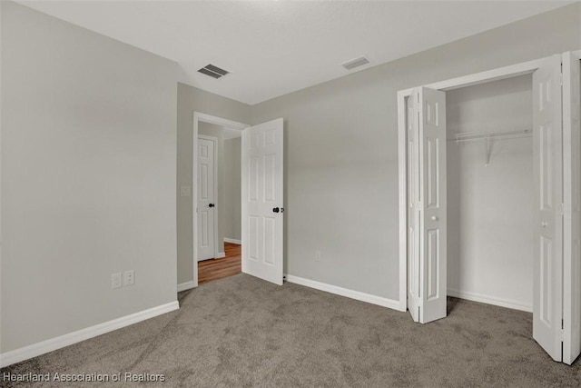 unfurnished bedroom with carpet floors and a closet