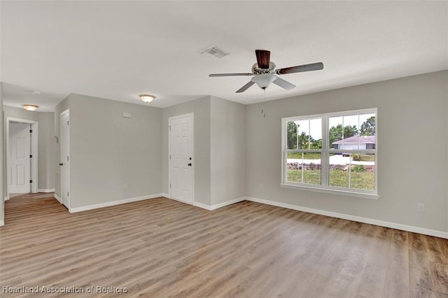 empty room featuring ceiling fan and light wood-type flooring