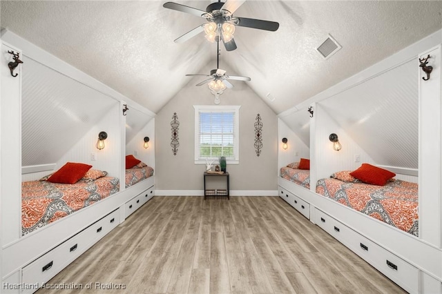 509 Bear Rd, Lake Placid, FL 33852 - bedroom featuring wood finished floors, a textured ceiling, vaulted ceiling, ceiling fan, and baseboards