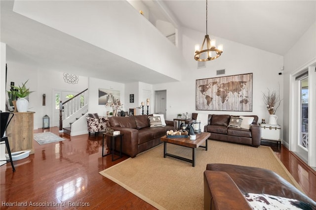 509 Bear Rd, Lake Placid, FL 33852 - living room featuring a chandelier, hardwood / wood-style flooring, stairs, high vaulted ceiling, and baseboards