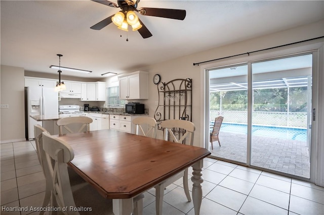 400 Spring Blvd, Sebring, FL 33876 - dining space with light tile patterned floors, ceiling fan, and baseboards