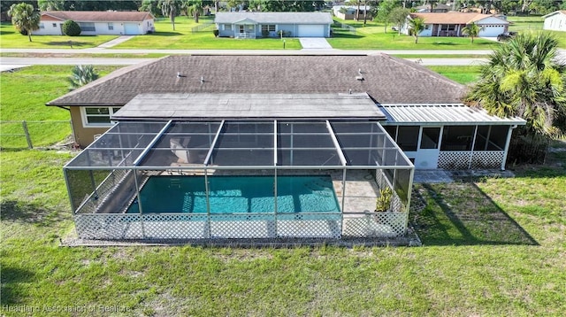 400 Spring Blvd, Sebring, FL 33876 - rear view of house featuring an outdoor pool, glass enclosure, a shingled roof, and a patio area