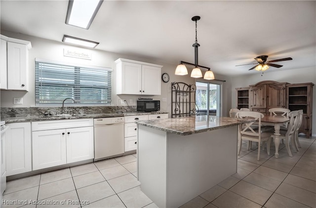 400 Spring Blvd, Sebring, FL 33876 - kitchen with dishwasher, black microwave, a sink, light tile patterned flooring, and stone countertops