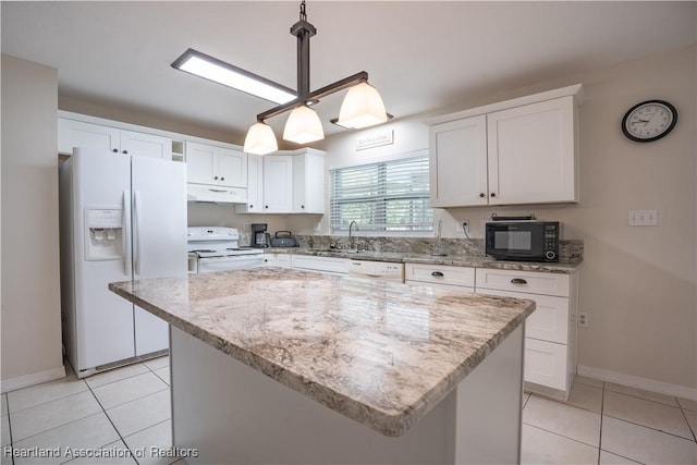 400 Spring Blvd, Sebring, FL 33876 - kitchen featuring white appliances, under cabinet range hood, a sink, and baseboards
