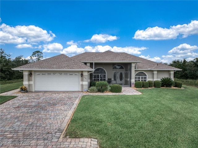 single story home with a garage and a front lawn