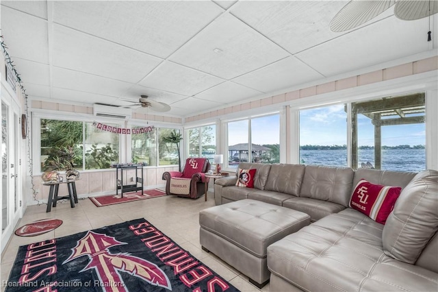 sunroom with a water view, ceiling fan, a wall mounted air conditioner, and a drop ceiling