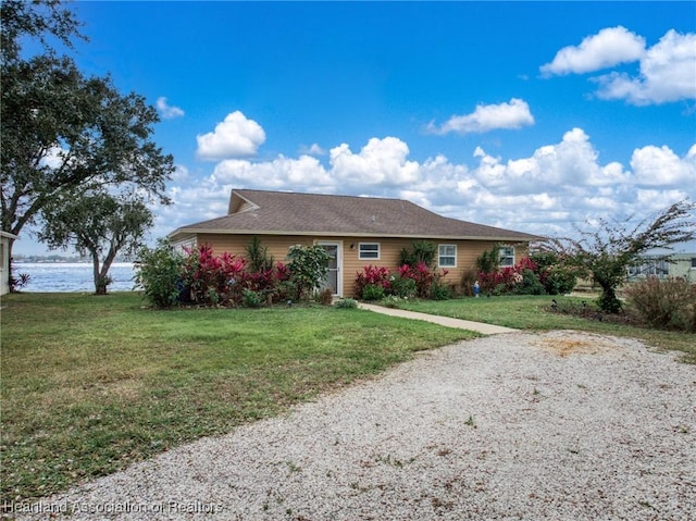 ranch-style house featuring a water view and a front yard