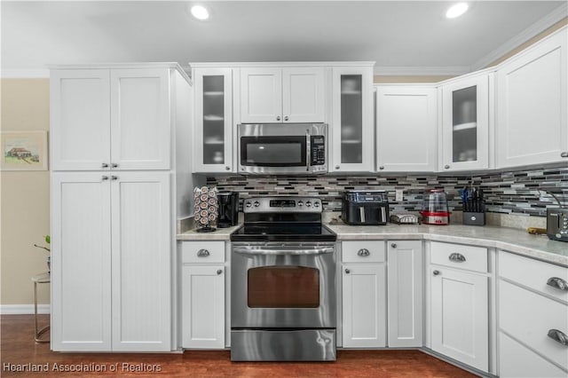 kitchen featuring white cabinetry, appliances with stainless steel finishes, and decorative backsplash