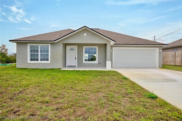 single story home with a front yard and a garage