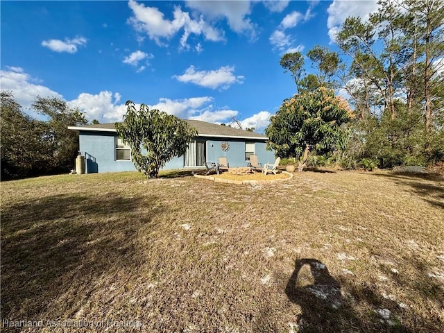 back of house with a lawn