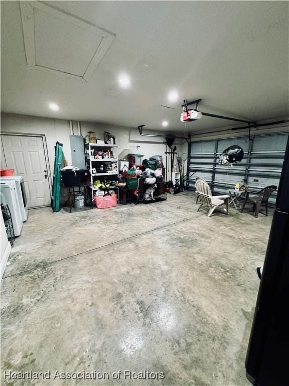 garage featuring a garage door opener, washing machine and dryer, and electric panel