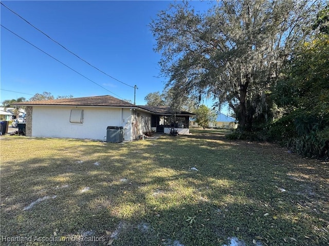 view of property exterior with cooling unit and a lawn