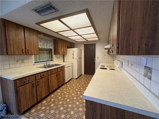 kitchen featuring sink, tasteful backsplash, ventilation hood, a textured ceiling, and white appliances