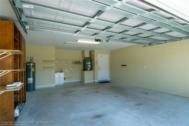 garage featuring a garage door opener, heating unit, and electric water heater