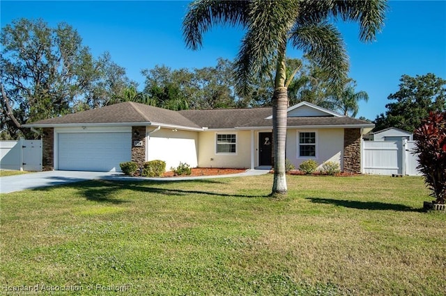 ranch-style home featuring a garage and a front lawn