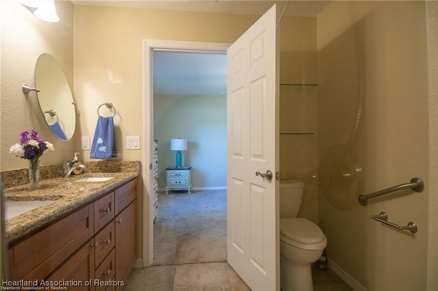 bathroom with tile patterned floors, toilet, and vanity