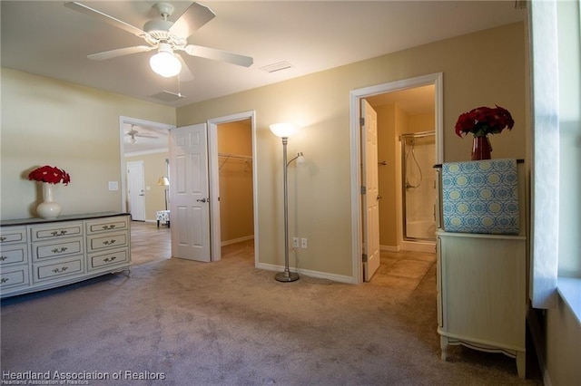 carpeted bedroom featuring ceiling fan, a walk in closet, a closet, and connected bathroom