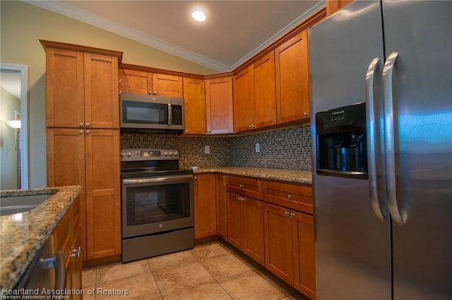 kitchen with stainless steel appliances, decorative backsplash, vaulted ceiling, crown molding, and light stone counters