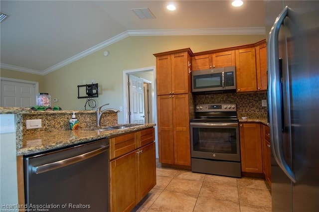 kitchen featuring vaulted ceiling, decorative backsplash, sink, crown molding, and stainless steel appliances