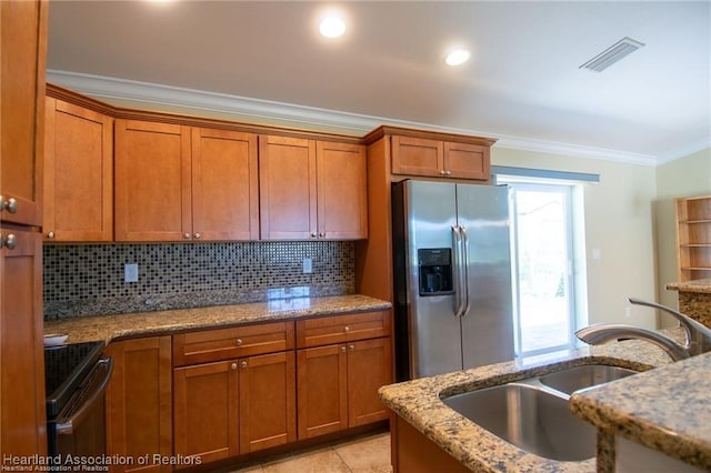 kitchen with backsplash, sink, crown molding, range with electric cooktop, and stainless steel fridge