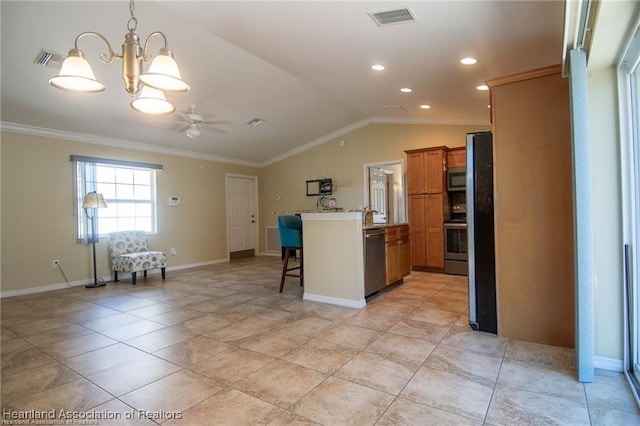 kitchen with appliances with stainless steel finishes, decorative light fixtures, vaulted ceiling, ornamental molding, and a breakfast bar