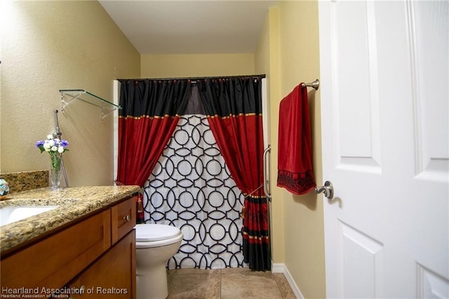 bathroom with toilet, tile patterned flooring, a shower with curtain, and vanity