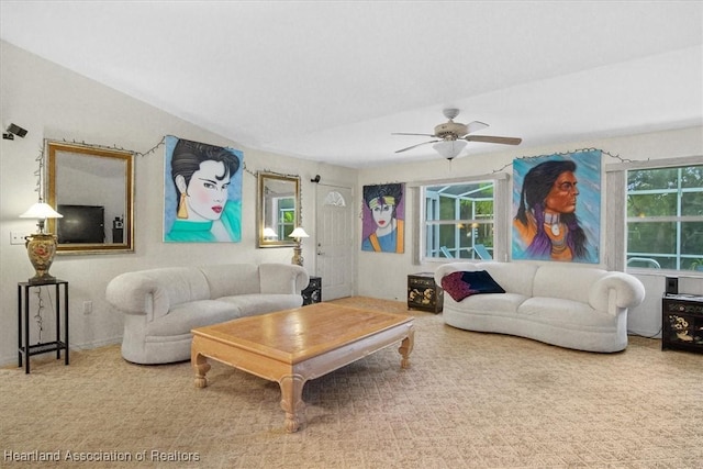 carpeted living room featuring vaulted ceiling and ceiling fan