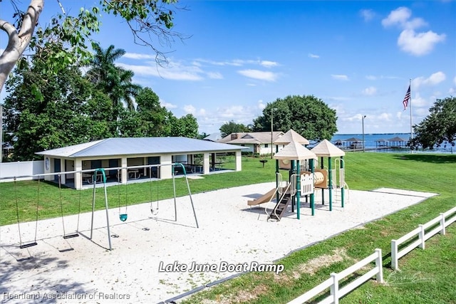 view of play area with a water view and a lawn