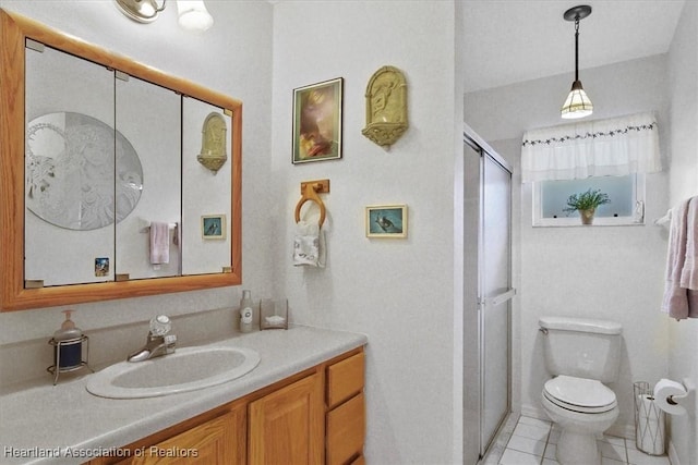 bathroom with toilet, vanity, tile patterned floors, and walk in shower