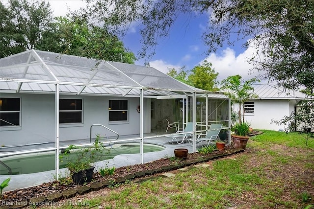 back of property with glass enclosure