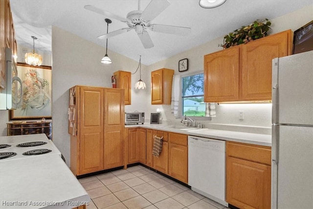 kitchen featuring pendant lighting, white appliances, ceiling fan with notable chandelier, sink, and light tile patterned floors