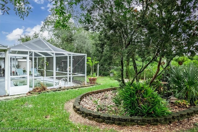 view of yard with glass enclosure