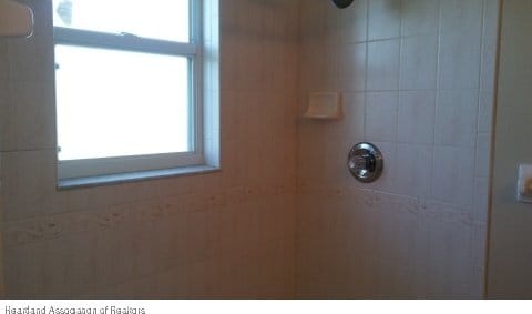 bathroom with tiled shower