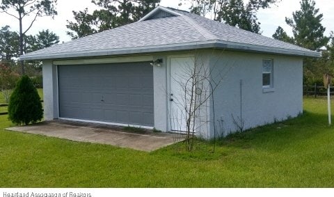 garage with a lawn