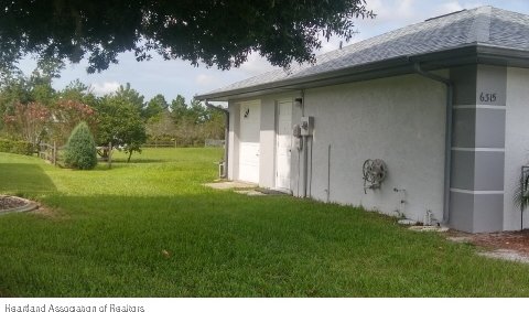 view of side of home featuring a lawn