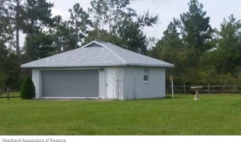 garage featuring a lawn