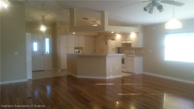 kitchen featuring white appliances, ventilation hood, hardwood / wood-style flooring, ceiling fan, and white cabinetry