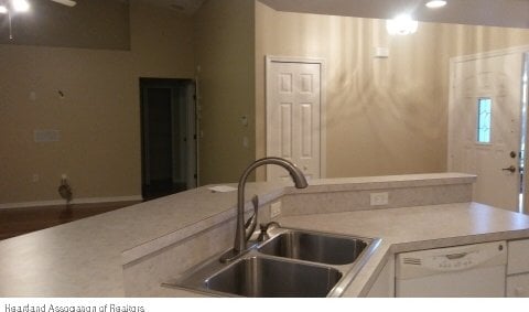 kitchen with white cabinetry, sink, and white dishwasher