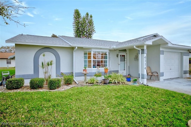 single story home with an attached garage, a front lawn, and stucco siding