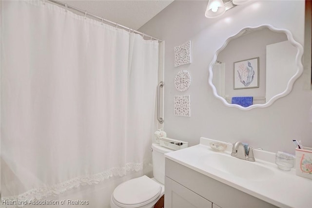 full bath featuring vanity and toilet