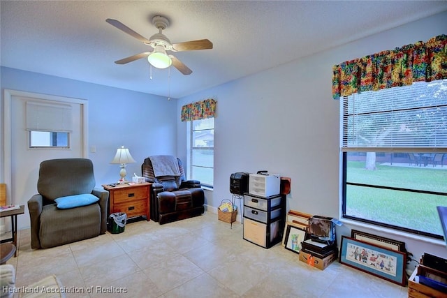 interior space featuring a ceiling fan and a textured ceiling