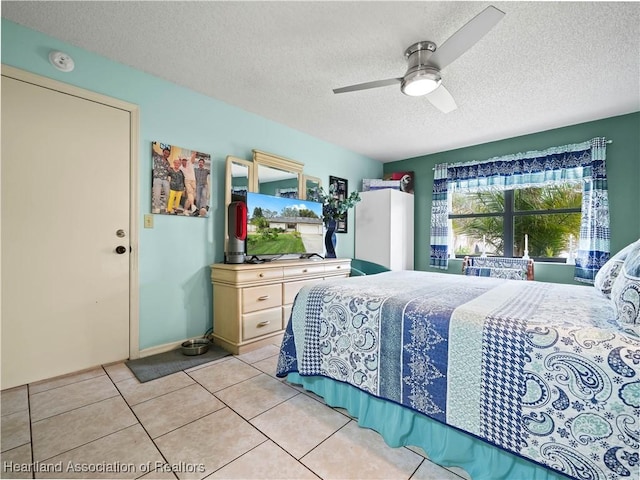 bedroom featuring light tile patterned floors, a textured ceiling, and ceiling fan