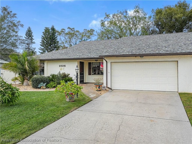 single story home featuring a garage and a front yard