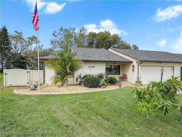 ranch-style home with a front yard and a garage